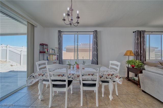 dining room with a notable chandelier and light tile patterned floors