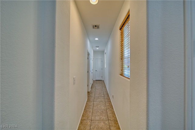 hall featuring light tile patterned floors