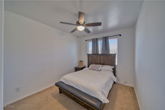 carpeted bedroom with a textured ceiling and ceiling fan