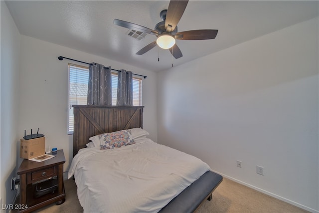 bedroom with ceiling fan and light colored carpet