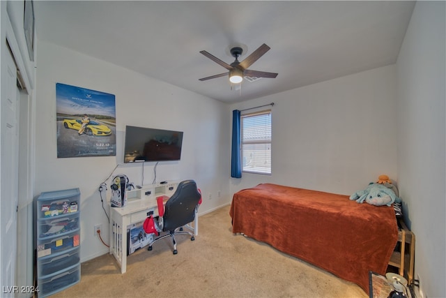 bedroom with a closet, ceiling fan, and light carpet