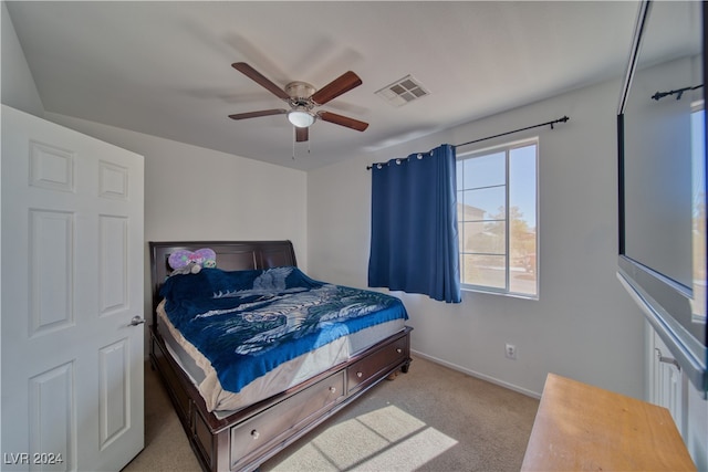 bedroom with light carpet and ceiling fan