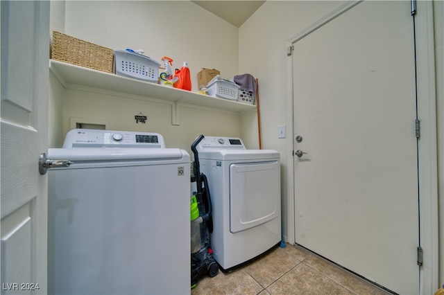 laundry room featuring light tile patterned floors and separate washer and dryer