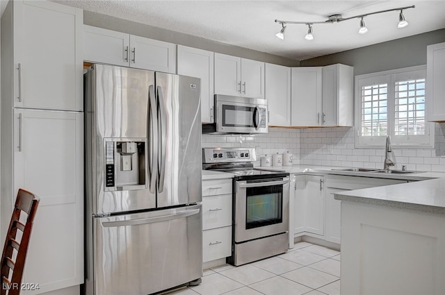 kitchen featuring sink, appliances with stainless steel finishes, and white cabinets