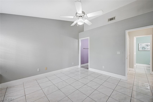 tiled spare room featuring ceiling fan