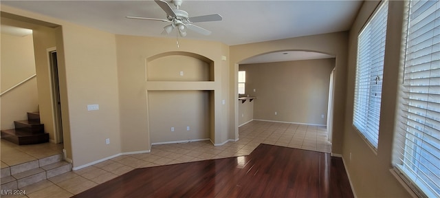 interior space with ceiling fan and light tile patterned floors