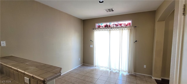 empty room with light tile patterned flooring