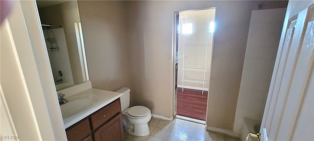 bathroom featuring hardwood / wood-style floors, vanity, a shower, and toilet