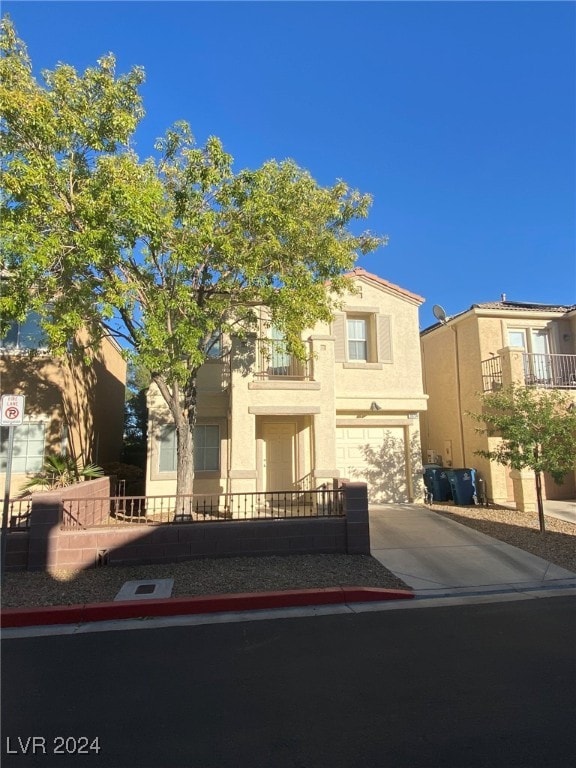 view of front of house featuring a garage and a balcony