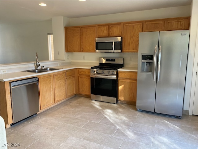 kitchen with sink, appliances with stainless steel finishes, and light tile patterned flooring