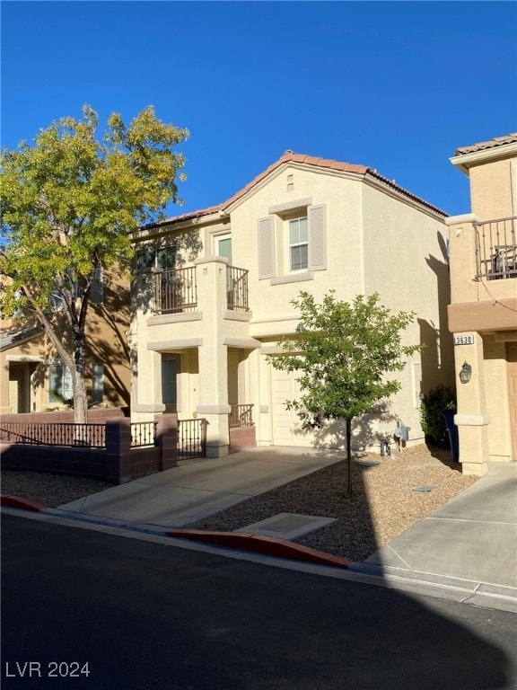 view of front of home with a garage and a balcony