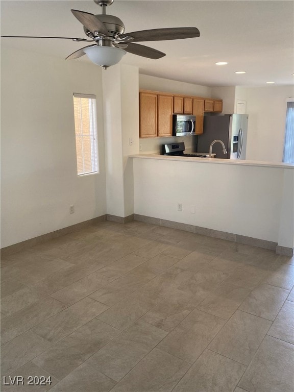 kitchen featuring appliances with stainless steel finishes and ceiling fan