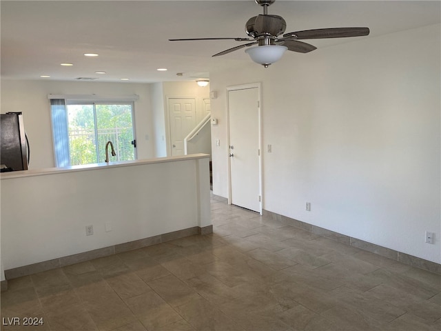 spare room featuring sink and ceiling fan