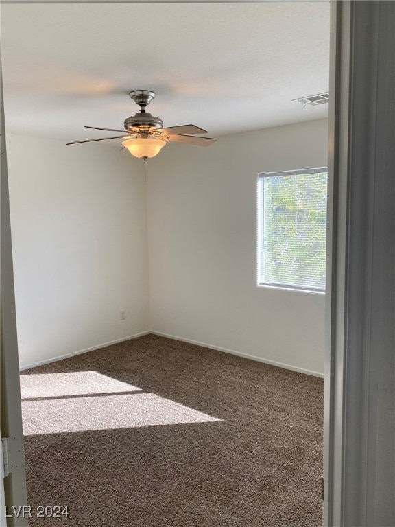 carpeted empty room featuring ceiling fan