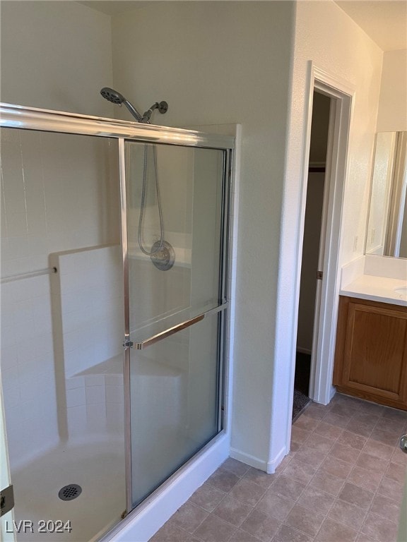 bathroom featuring vanity and a shower with shower door