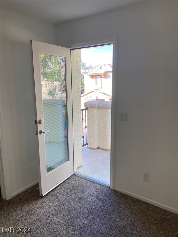 entryway featuring dark carpet