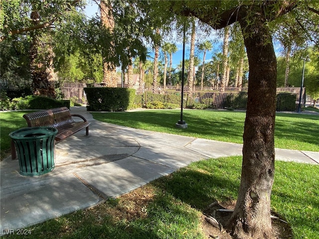 view of home's community featuring a patio area and a lawn