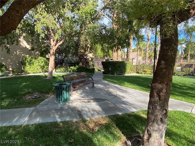 view of property's community with a patio and a lawn