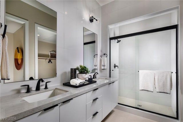 bathroom featuring vanity and a shower with door