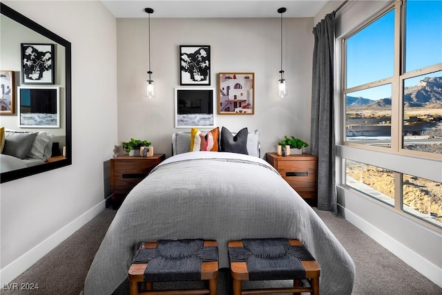 bedroom with carpet flooring and a mountain view