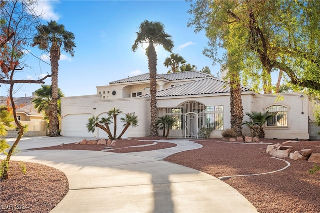 mediterranean / spanish home featuring a garage