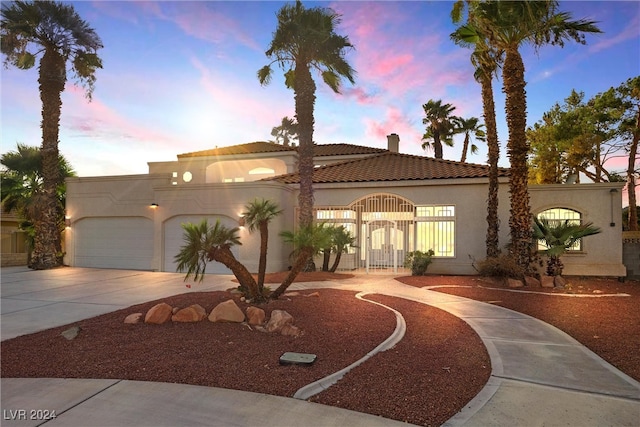 mediterranean / spanish-style house featuring a garage