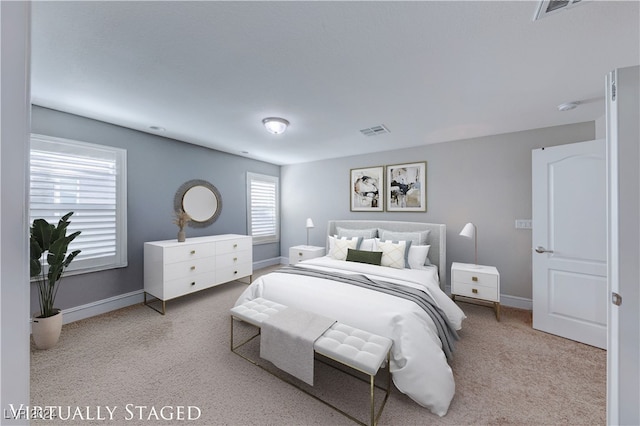 carpeted bedroom featuring multiple windows