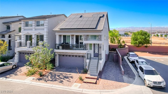 view of front of house featuring solar panels and a garage