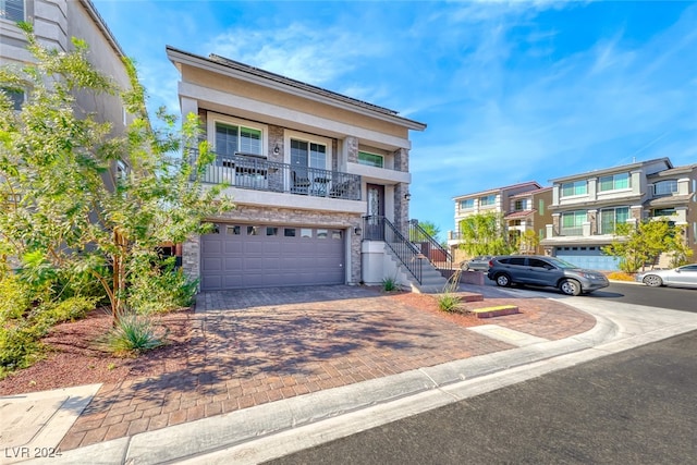 view of front of property with a garage and a balcony