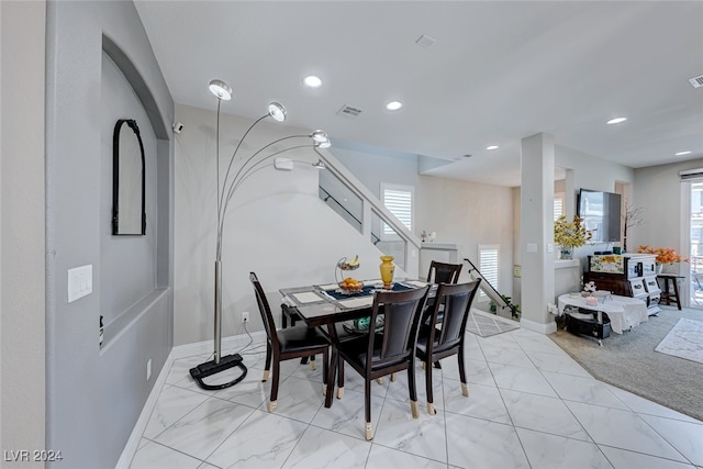 carpeted dining space with plenty of natural light