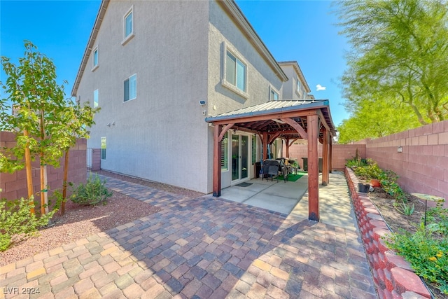 back of house with a gazebo and a patio