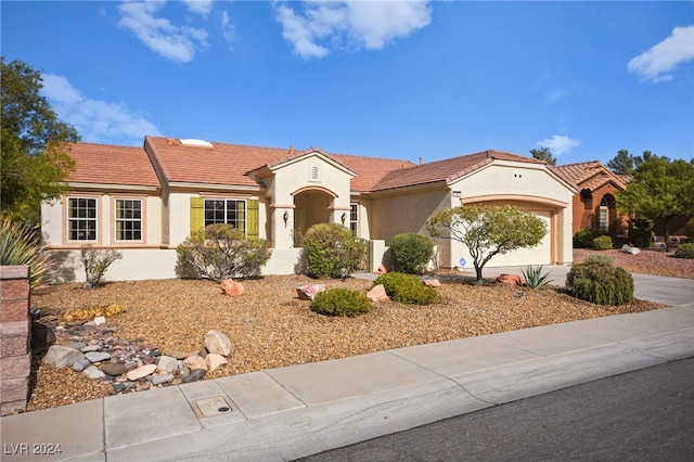 mediterranean / spanish-style house with a garage