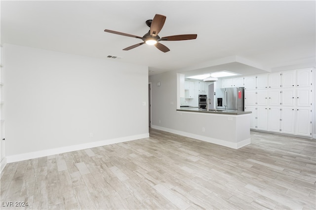 unfurnished living room with ceiling fan and light hardwood / wood-style floors