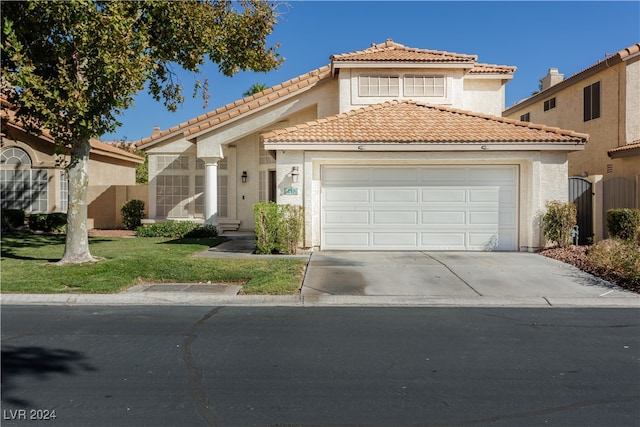 mediterranean / spanish home with a front yard