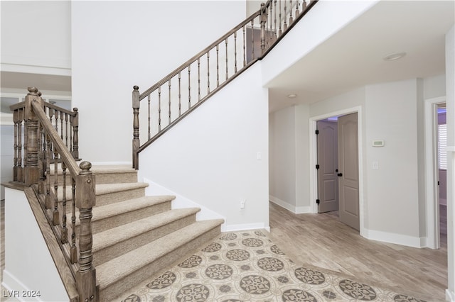 stairway featuring wood-type flooring