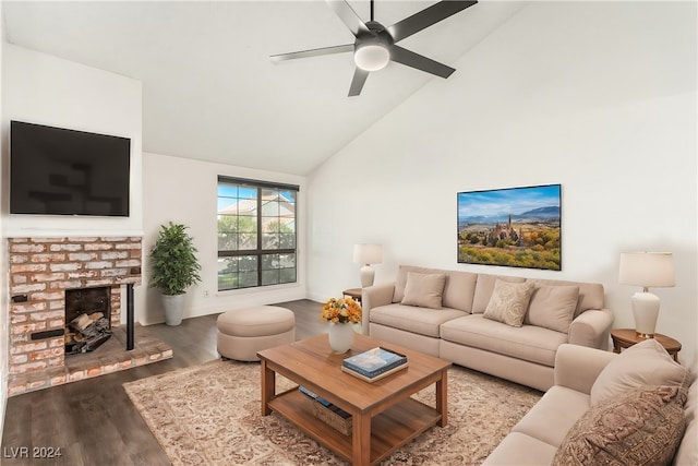 living room with ceiling fan, hardwood / wood-style floors, high vaulted ceiling, and a brick fireplace