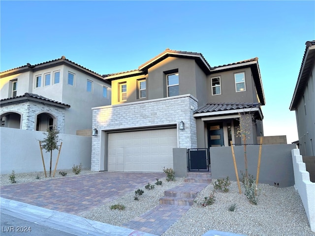 mediterranean / spanish-style house with a garage