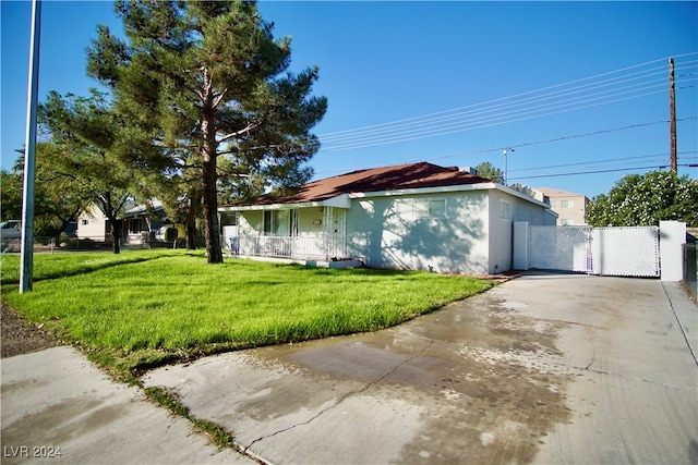 view of side of home with a yard