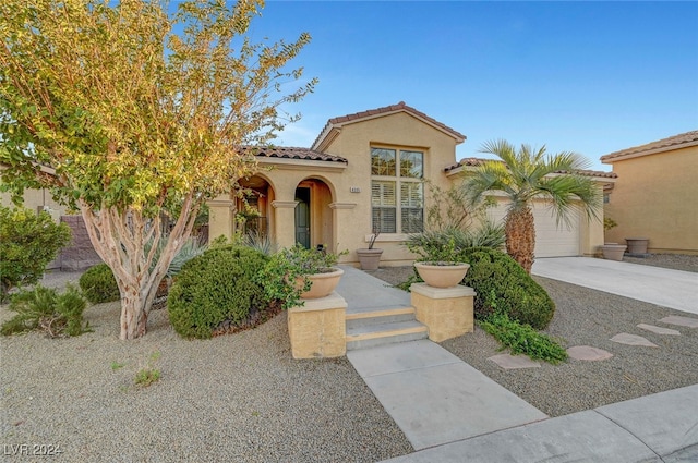 mediterranean / spanish-style home featuring a garage