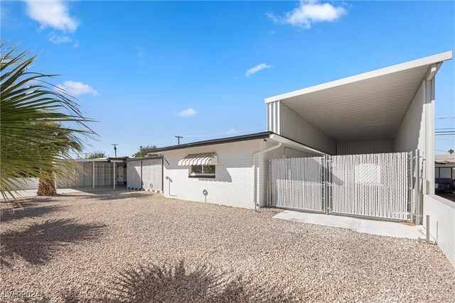 rear view of property featuring a carport