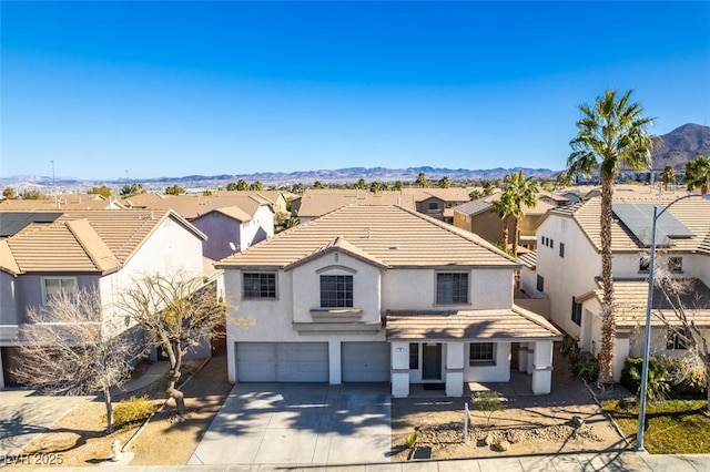 view of front property featuring a mountain view and a garage