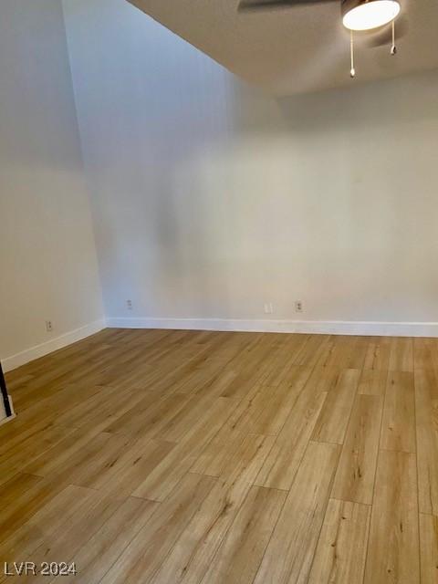 unfurnished room with ceiling fan and light hardwood / wood-style flooring