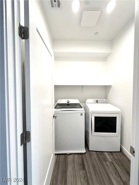 9847 Kings Glen St, Las Vegas, NV 89141 - clothes washing area with washer and dryer, dark wood-style flooring, and baseboards
