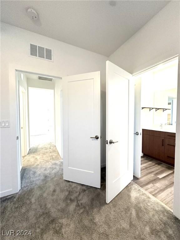 9847 Kings Glen St, Las Vegas, NV 89141 - unfurnished bedroom featuring carpet flooring and lofted ceiling