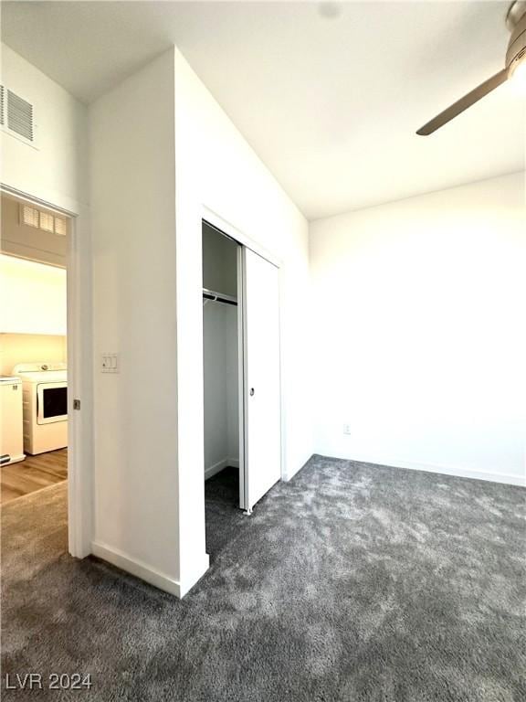9847 Kings Glen St, Las Vegas, NV 89141 - unfurnished bedroom with independent washer and dryer, dark carpet, and a closet