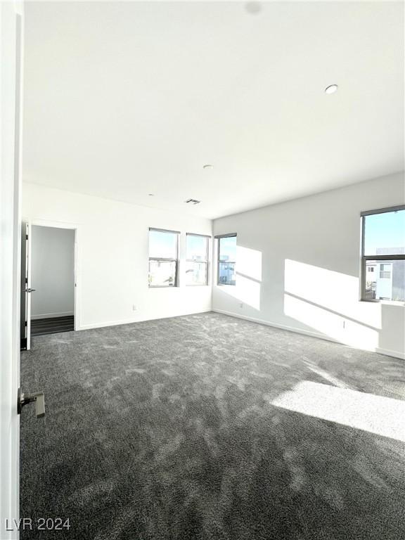 9847 Kings Glen St, Las Vegas, NV 89141 - unfurnished room featuring healthy amount of natural light, carpet, and baseboards