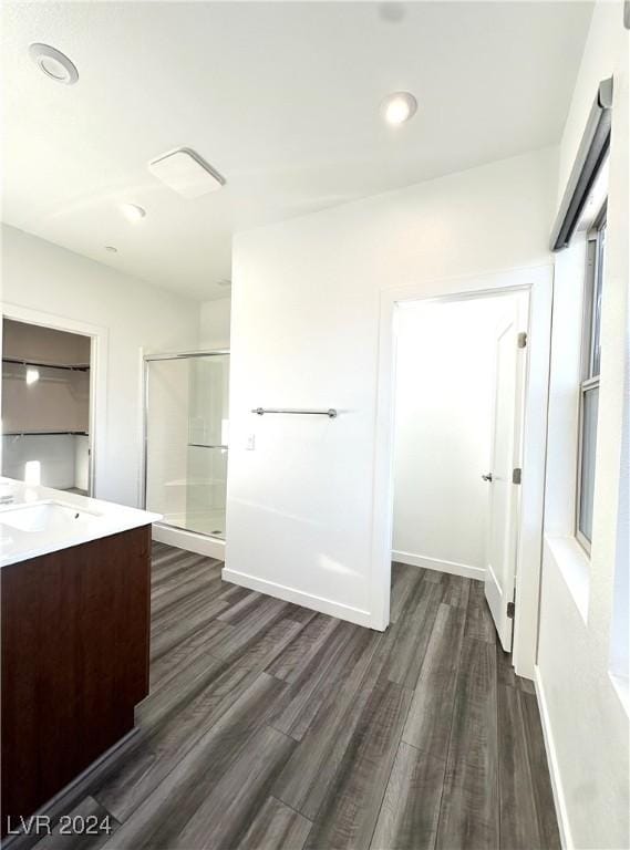 9847 Kings Glen St, Las Vegas, NV 89141 - full bath featuring wood finished floors, a stall shower, vanity, baseboards, and recessed lighting