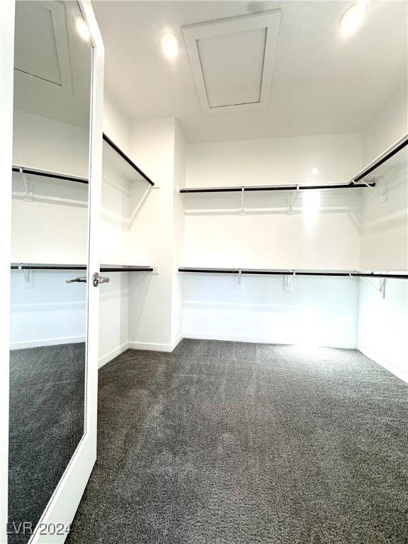 9847 Kings Glen St, Las Vegas, NV 89141 - walk in closet with dark carpet and attic access