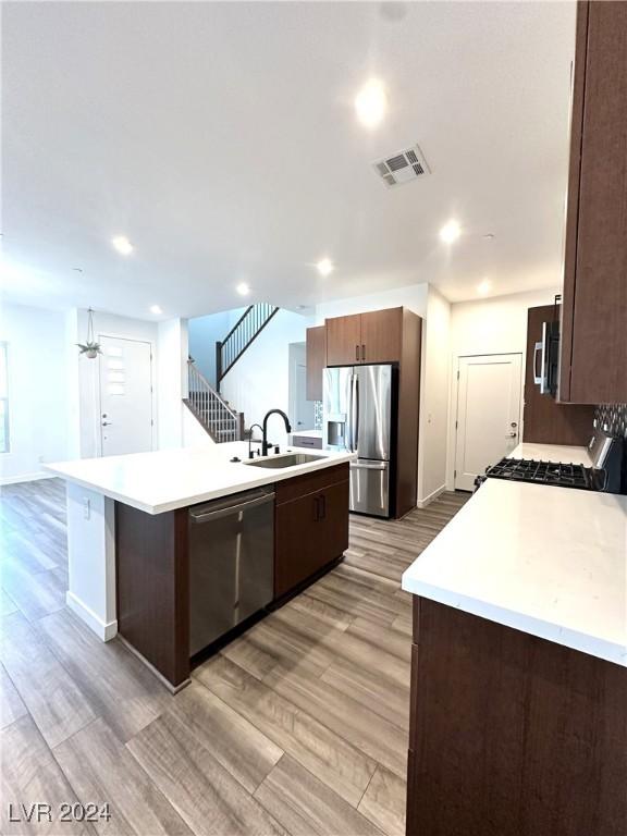 9847 Kings Glen St, Las Vegas, NV 89141 - kitchen featuring stainless steel appliances, light countertops, a kitchen island with sink, a sink, and recessed lighting