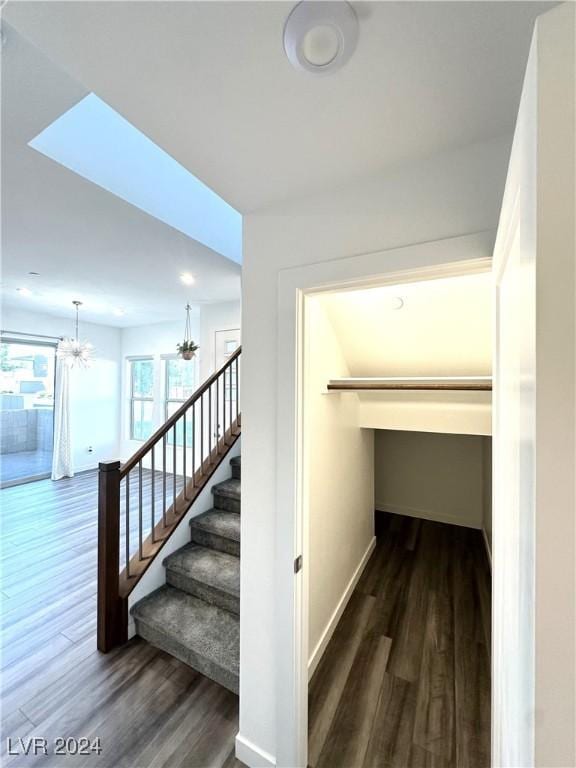 9847 Kings Glen St, Las Vegas, NV 89141 - stairway with wood finished floors, a chandelier, and baseboards
